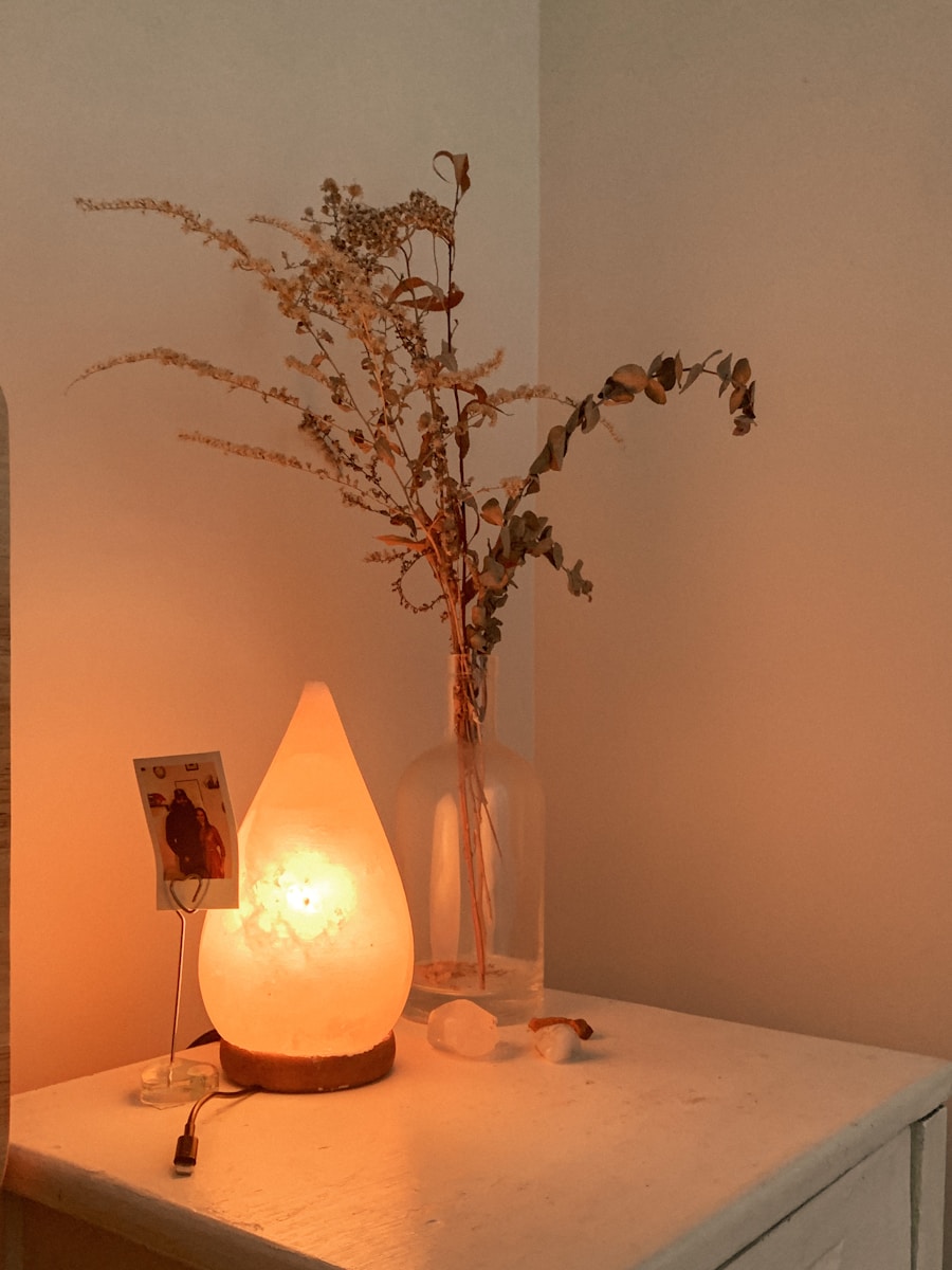 A vase of flowers beside a candle in a treatment room